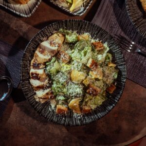 Appetizing Caesar salad with grilled chicken, croutons, and Parmesan cheese, perfect for a gourmet meal.